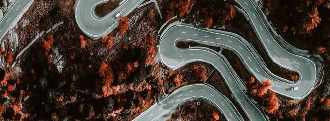 a picture of a curvy road on the mountains